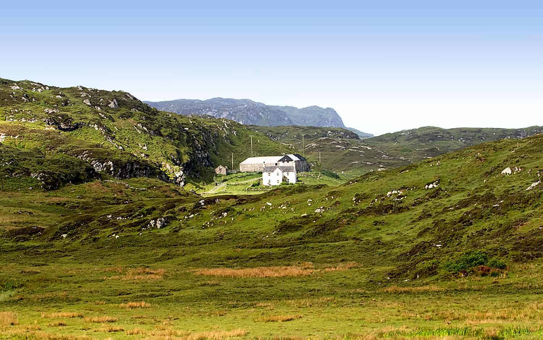 A view of Balnahard farmhouse in Colonsay, amongst the hills